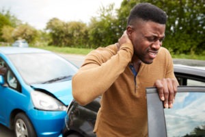 a black man with neck pain after a car accident