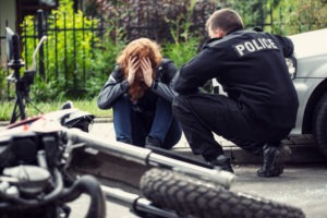 a policeman talking to a victim of a motorcycle crash