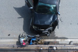 car crashing motorcycle into the guardrail