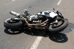 motorcycle lying in the road in the sun