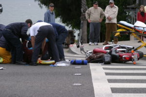 people tending to a motorcycle accident victim