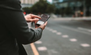 Los Angeles Uber and Lyft Ridesharing Accident man using smartphone to hail rideshare driver