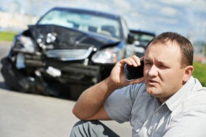 upset man on phone after auto collision